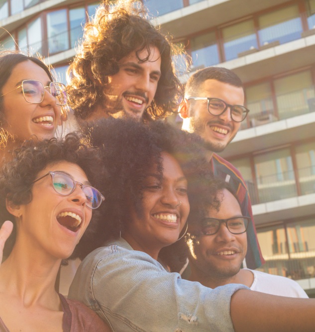 joyful-multiethnic-friends-taking-funny-group-selfie